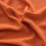 Tissu orange vif à pois blanc